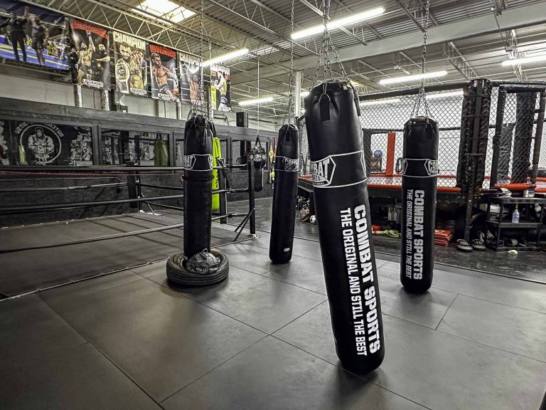 Free-standing heavy bags lined up on the striking floor